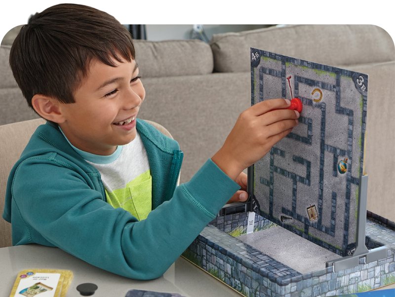 Boy playing a two-sided maze game